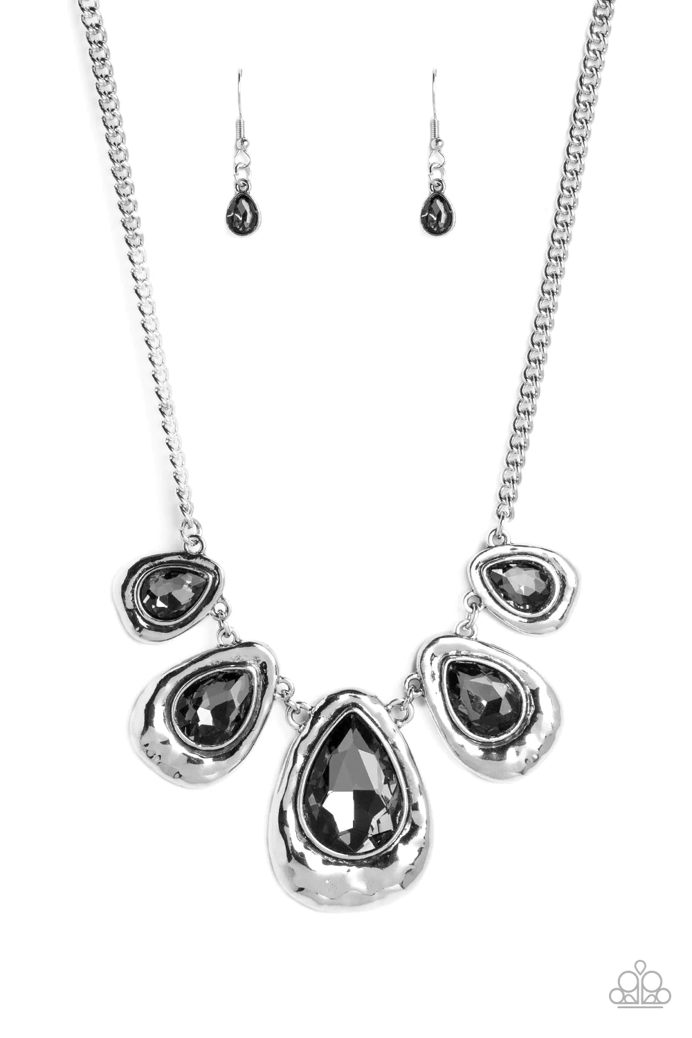 Paparazzi Accessories Formally Forged - Silver Delicately hammered in shimmer, a collection of shiny silver teardrops link below the collar for an edgy statement-making look. Set in each hammered frame, faceted, smoky teardrop gems add a dramatic pop of c