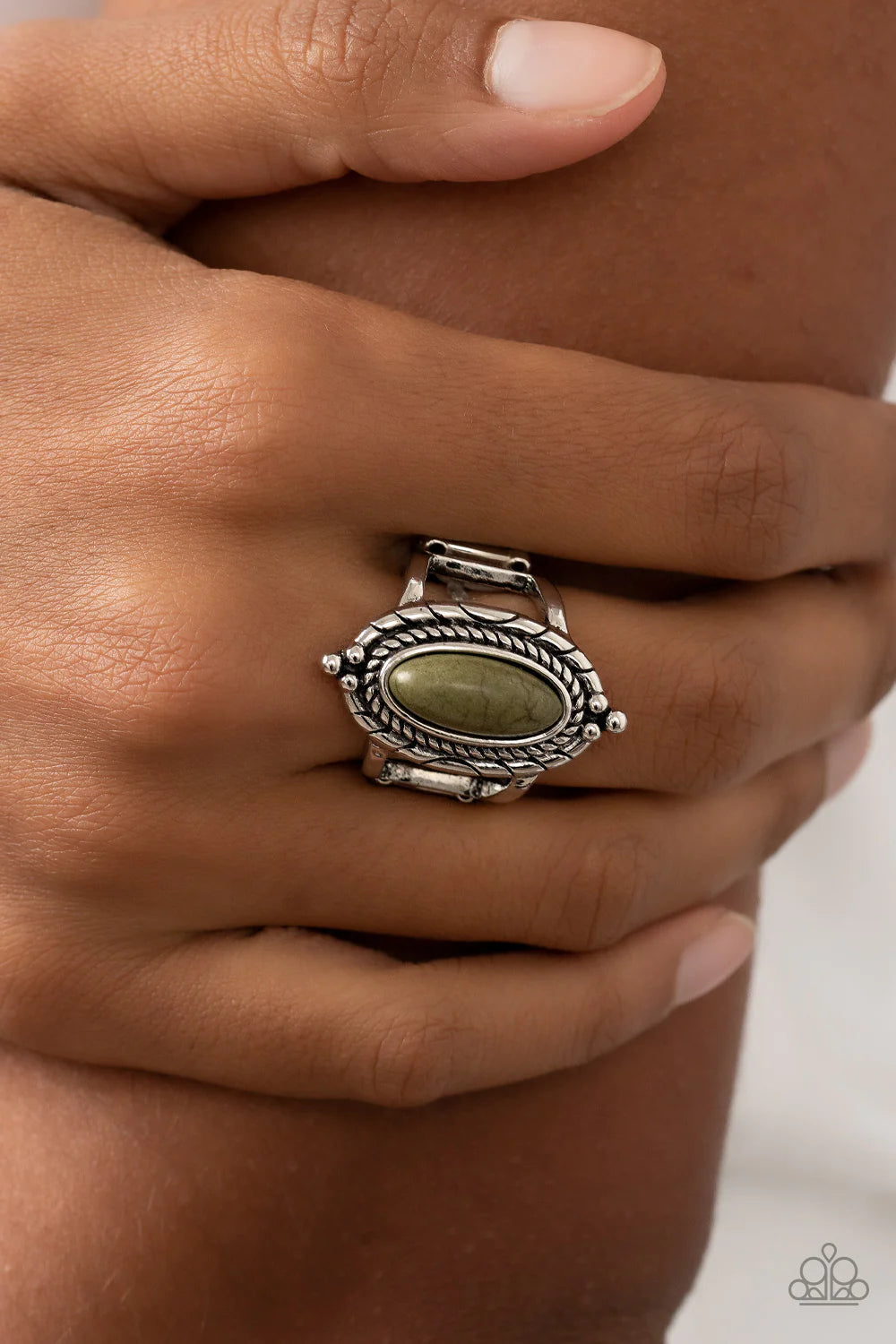 Paparazzi Accessories Mojave Metro - Green An oblong Olive Branch stone adorns the center of a ring of spun rope-like silver inside of a textured and studded silver frame, creating a colorful artisanal centerpiece atop the finger. Features a stretchy band