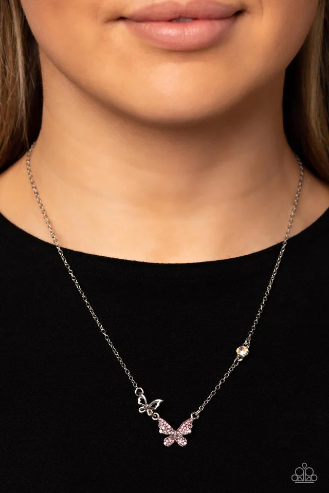 Paparazzi Accessories Can’t BUTTERFLY Me Love - Pink A silver butterfly, dotted in dainty light rose rhinestones, hangs from the bottom of a dainty silver chain. A smaller, airy silver butterfly appears to be in mid-flight as it's tilted to its side and b