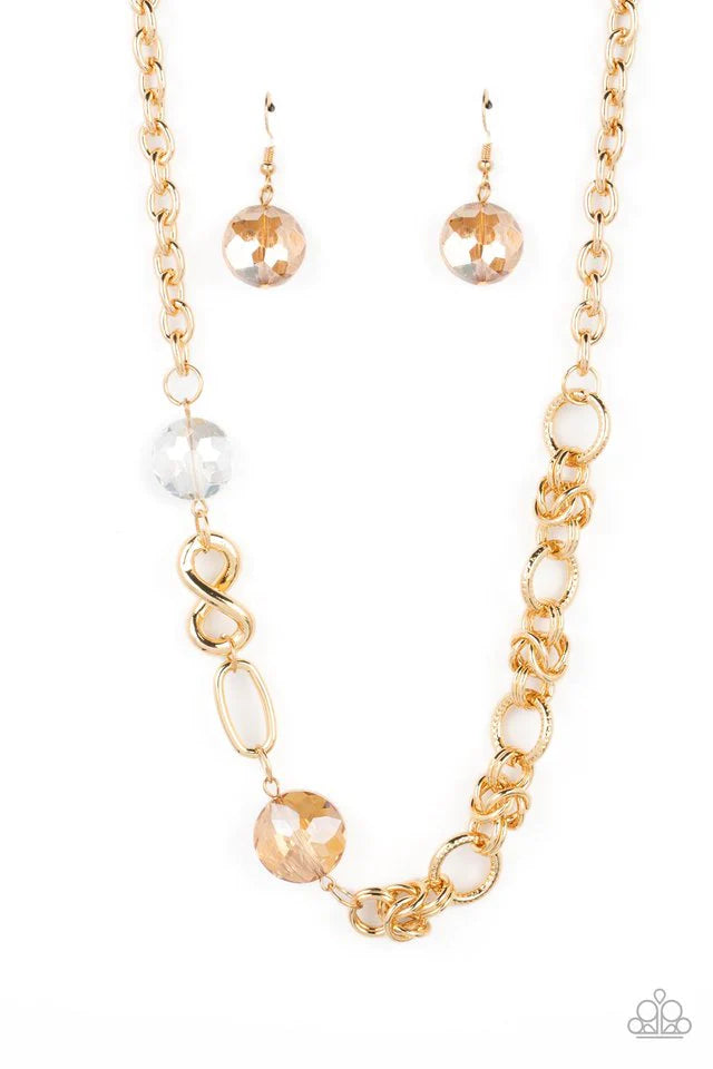 Paparazzi Accessories Celestially Celtic - Gold Thick links of gold twist into Celtic knot-like details, linking together with textured gold hoops along the collar. A pair of faceted, saucer-shaped crystal beads, dipped in a reflective gold coating and bo