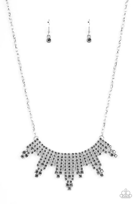 Paparazzi Accessories Skyscraping Sparkle - Silver Featuring studded silver fittings, glitzy rows of sparkly hematite rhinestones stack into gritty towers that curve below the collar for an edgy effect. Features an adjustable clasp closure. Sold as one in