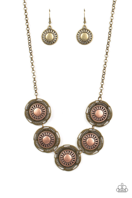 Paparazzi Accessories Desert Decor - Multi Studded brass bars asymmetrically arc around studded brass petals that bloom from stenciled copper centers. The handcrafted frames delicately link below the collar, creating a rustic statement piece. Features an