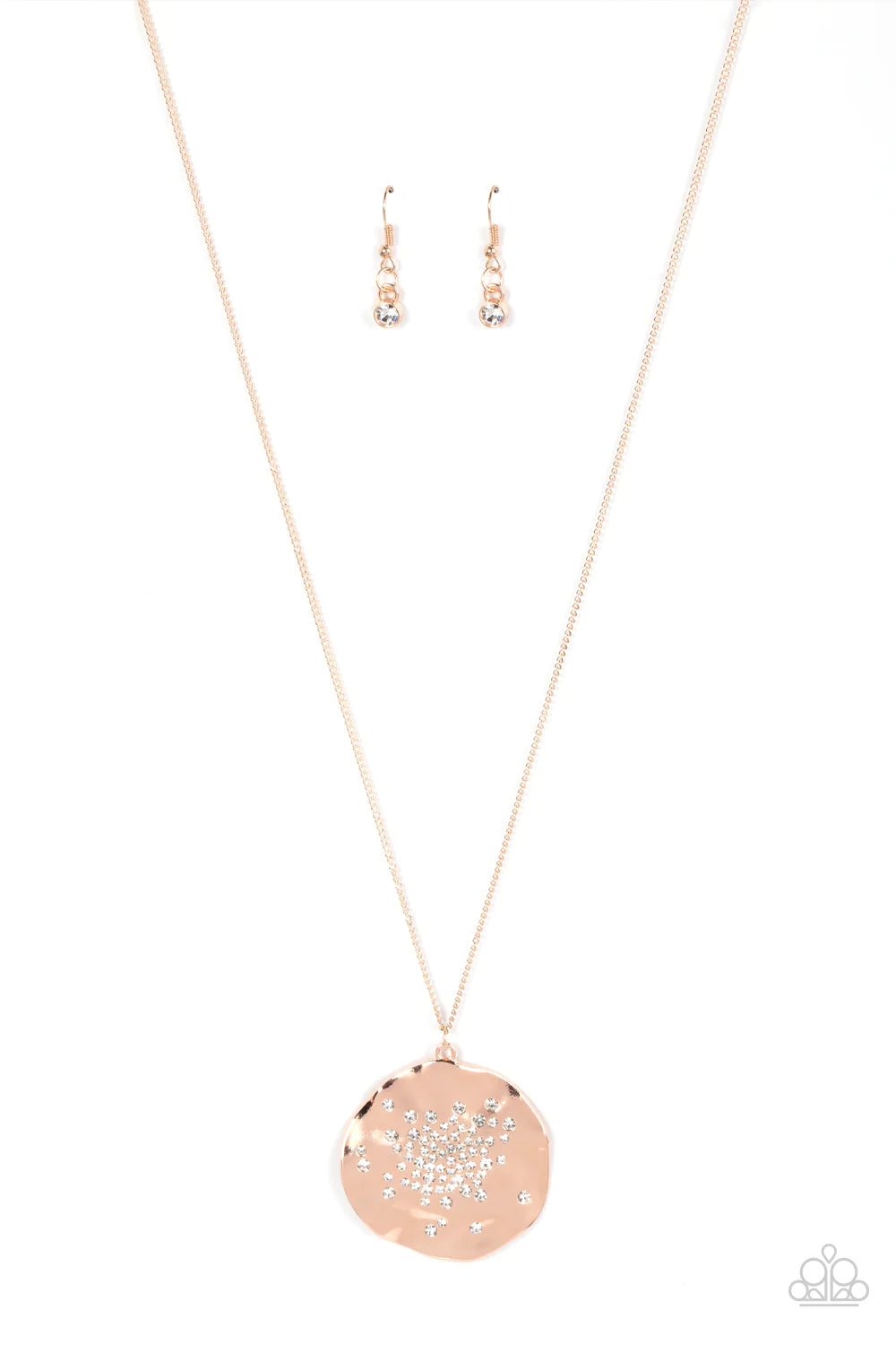 Paparazzi Accessories Boom and COMBUST - Rose Gold Dainty white rhinestones are haphazardly sprinkled across the front of an oversized and hammered rose gold disc, resulting in an explosion of shimmer at the bottom of an extended rose gold chain. Features