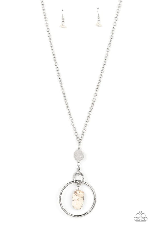 Paparazzi Accessories Keep The Piece - White A chiseled piece of white stone swings from the top of interconnected silver hoops. Infused with an additional hammered hoop and hammered silver disc, the stacked pendant attaches to the bottom of a bulky silve