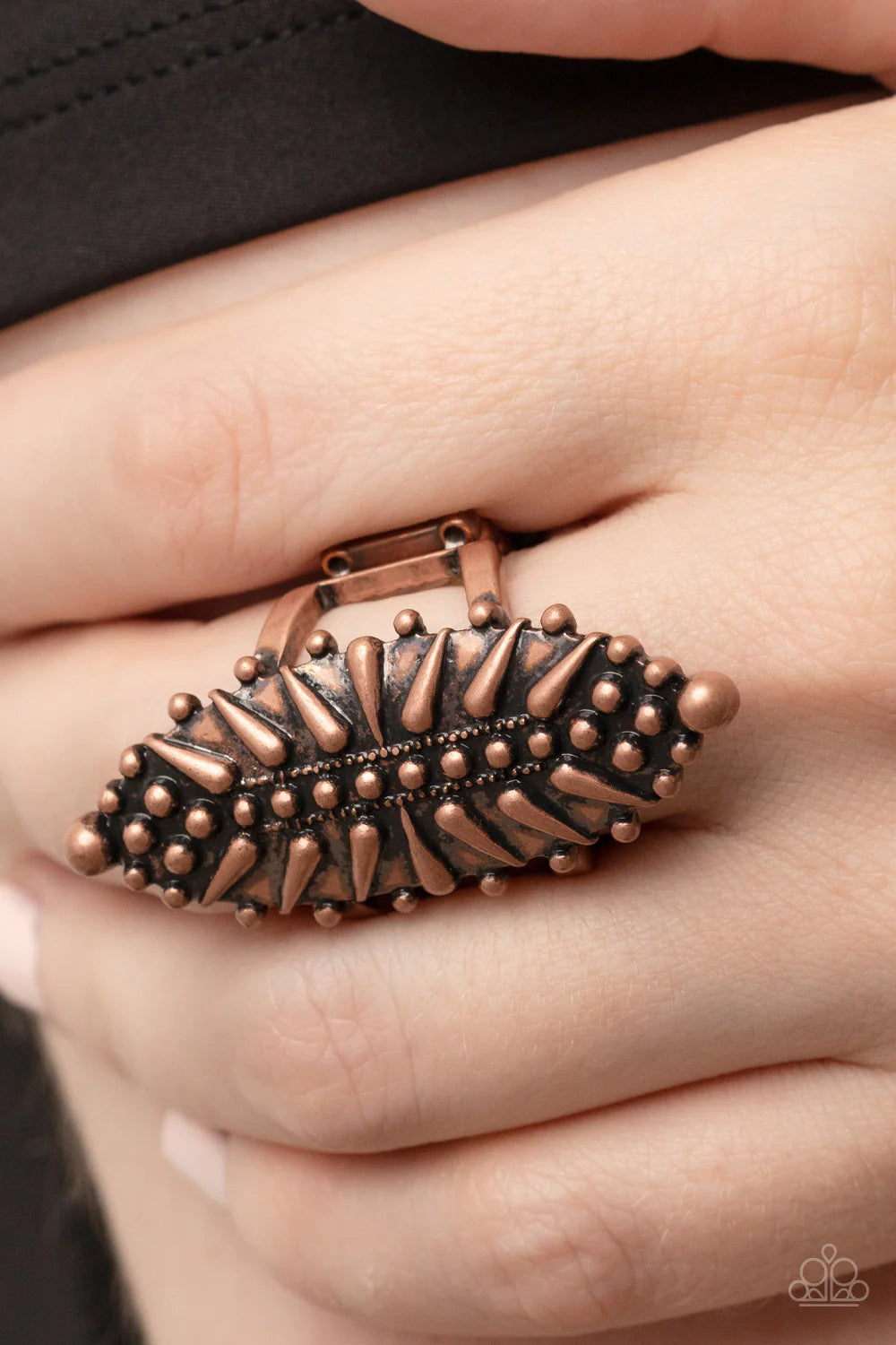 Paparazzi Accessories Bump, Set, Spike! - Copper An oblong and oval copper frame is studded in rustic dot and spike-like details, resulting in an edgy centerpiece atop the finger. Features a stretchy band for a flexible fit. Sold as one individual ring. J