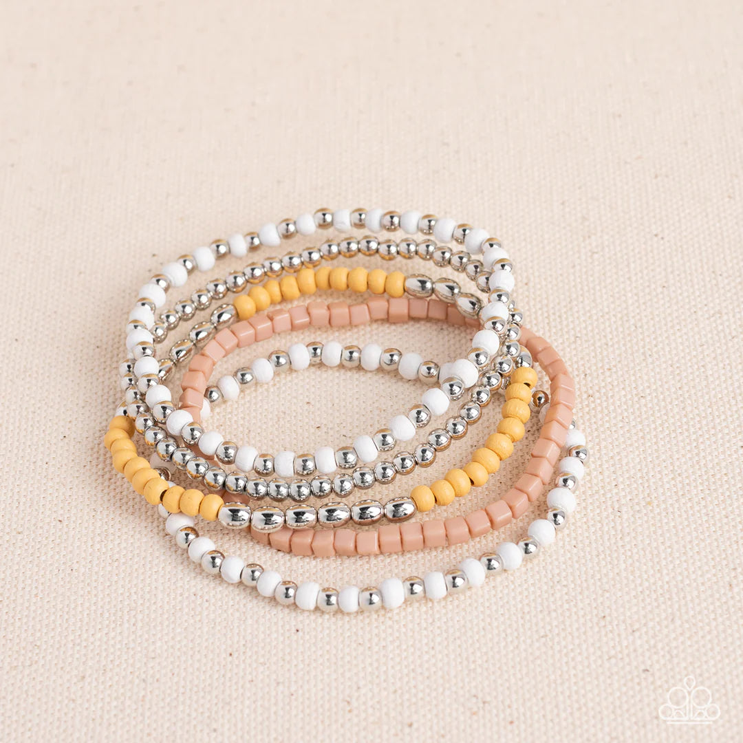 Paparazzi Accessories Adventure is Calling - Brown Featuring the neutral shades of white, brown, silver, and Daffodil, an adventurous assortment of round and cube beads are threaded along stretchy bands around the wrist for a colorfully layered look. Jewe