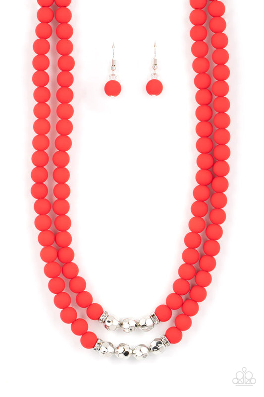 Paparazzi Accessories Summer Splash - Red Threaded along invisible wires, matte-finished Poinciana beads give way to center sections of white rhinestone encrusted rings and faceted silver beads. The vivacious display layers below the collar, creating a su