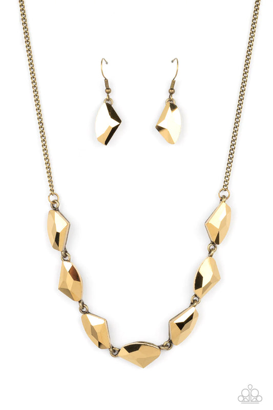 Paparazzi Accessories Raw Rapture - Brass A jagged collection of aurum rhinestones falls along the neckline in a fierce display. The asymmetrical cuts of each rhinestone are emphasized by their dramatic faceted surfaces, bouncing light in every direction