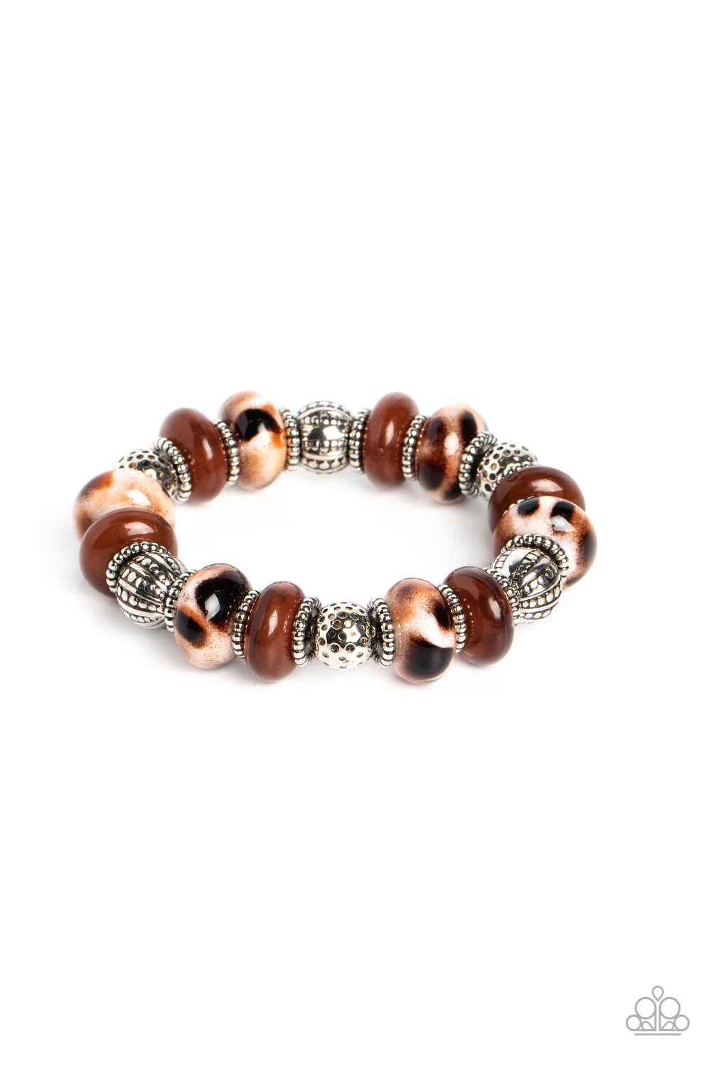 Paparazzi Accessories Warped Wayfarer - Brown An earthy collection of dotted silver beads, rounded milky Caramel Café beads, studded silver rings, brown-spotted ceramic-like beads and textured silver beads are threaded along an elastic stretchy band aroun