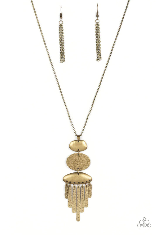 Paparazzi Accessories After the ARTIFACT - Brass A hammered brass oval frame is flanked between two asymmetrical brass frames at the bottom of a lengthened brass chain. Hammered brass pendulums swing from the bottom of the stacked pendant, adding playful