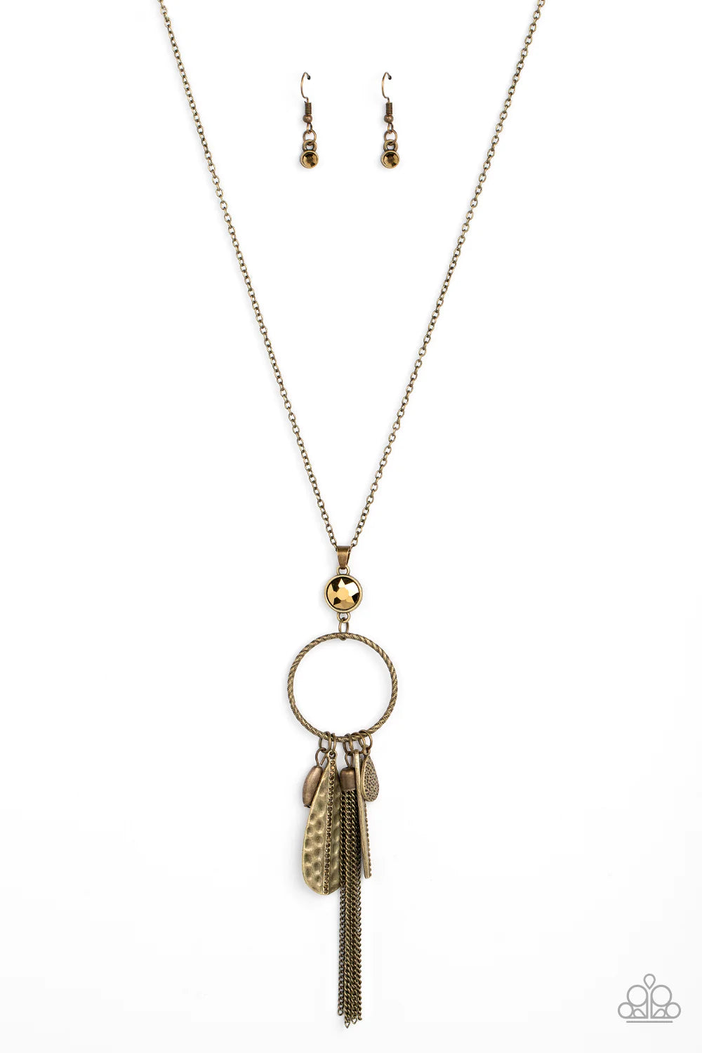 Paparazzi Accessories Tastefully Tasseled - Brass Featuring both smooth and hammered finishes, dainty aurum rhinestones, and a tassel of dainty chains, a sassy collection of brass charms swings from the bottom of a textured circle. A faceted aurum gem sit