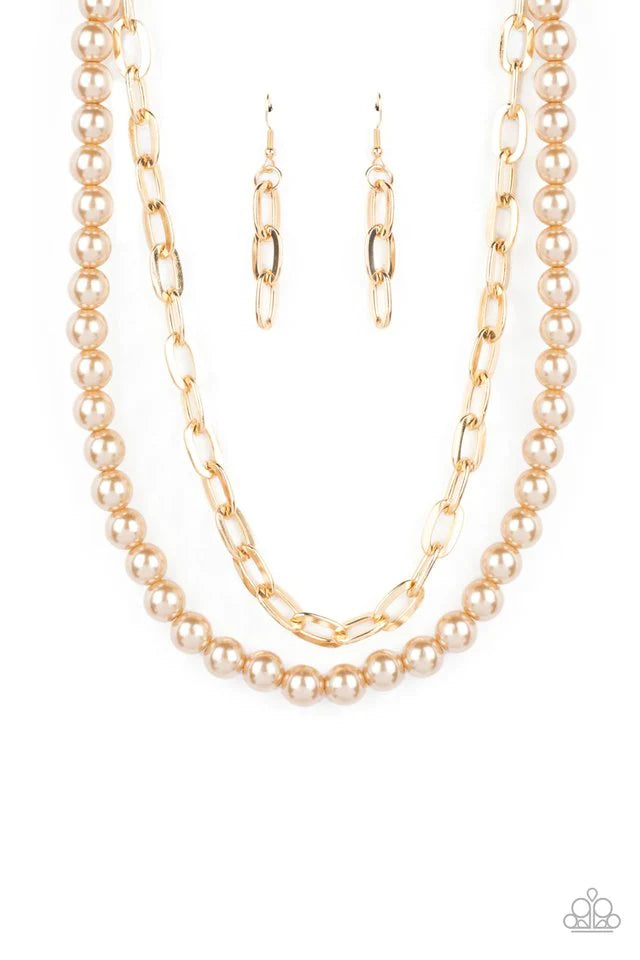 Paparazzi Accessories Suburban Yacht Club - Brown A string of classic pearls in a soft, brown hue is layered with a strand of oversized gold links, creating a gorgeous collision of refinement and grit as they lay along the collar. Features an adjustable c