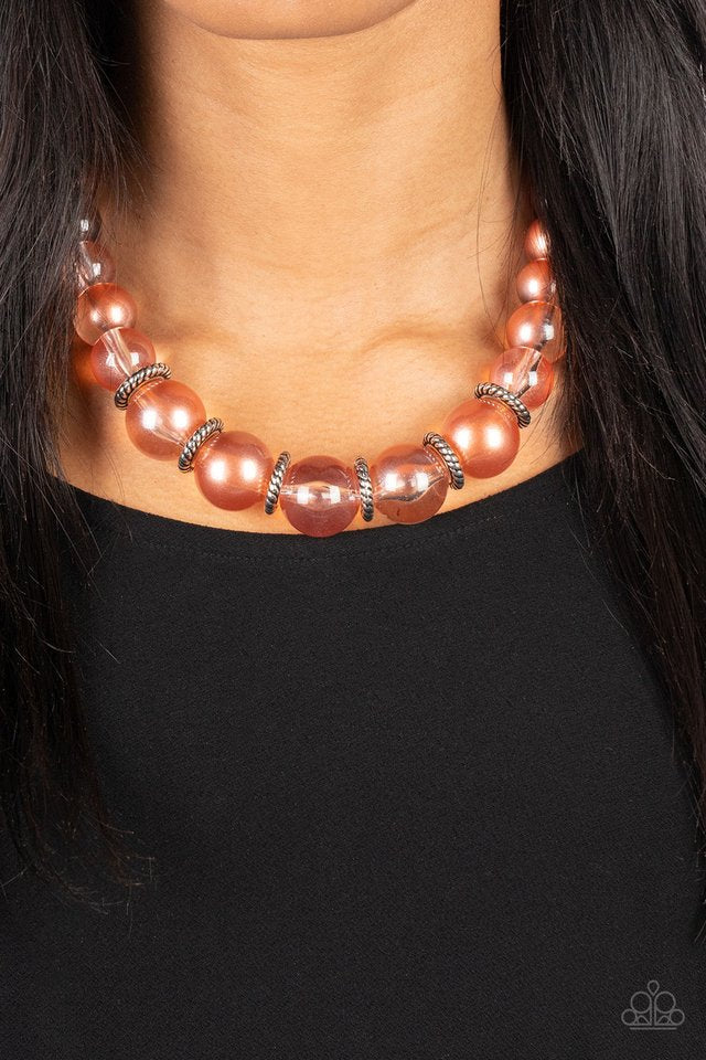 Paparazzi Accessories Marina Mirage - Orange Lightly brushed in a pearly Spun Sugar shimmer, glassy translucent beads gradually increase in size as they are threaded along an invisible wire below the collar. Textured silver rings separate the largest bead