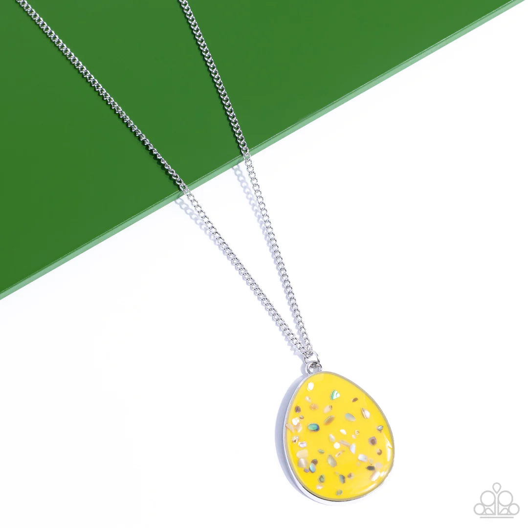 Paparazzi Accessories Shimmering Seafloors - Yellow Featuring a shell-like iridescence, shimmery flecks are sprinkled along a mustard yellow backdrop inside of a glassy casing. The colorful teardrop swings from the bottom of an extended silver chain, crea