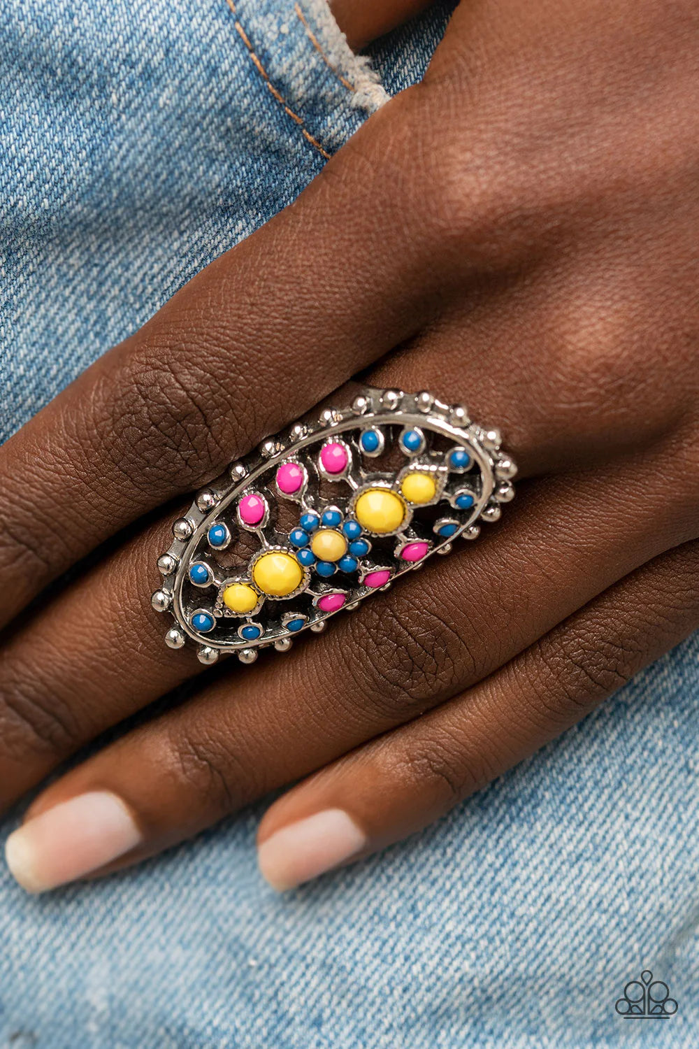 Paparazzi Accessories Sonoran Solstice - Blue Dainty Illuminating, Mykonos Blue, and Fuchsia Fedora beads dot the airy front of a studded silver oval frame, creating a colorful floral pattern across the finger. Features a stretchy band for a flexible fit.