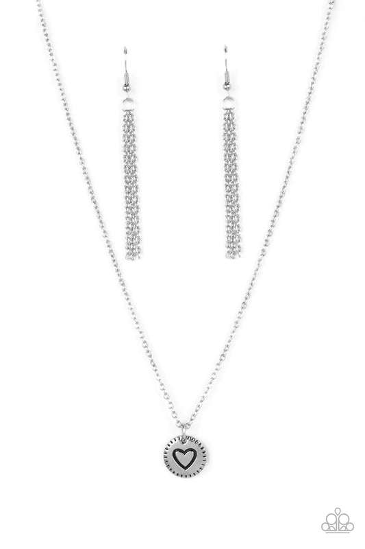 Paparazzi Accessories Stamped Sentiment - Silver Stamped in a heart burst pattern, a round silver pendant is suspended from a dainty silver chain for a sentimentally sleek design. Features an adjustable clasp closure. Sold as one individual necklace. Incl