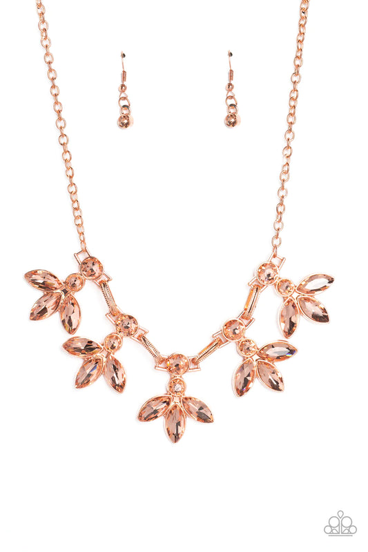 Paparazzi Accessories Dauntlessly Debonair - Copper Featuring warm marquise style cuts, oversized peachy gems fan out from an interconnected, circular peachy rhinestone display. Separating the warm florals, airy shiny copper ovals, stamped with a dot moti