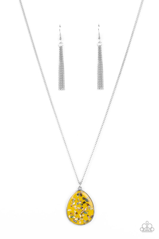 Paparazzi Accessories Shimmering Seafloors - Yellow Featuring a shell-like iridescence, shimmery flecks are sprinkled along a mustard yellow backdrop inside of a glassy casing. The colorful teardrop swings from the bottom of an extended silver chain, crea