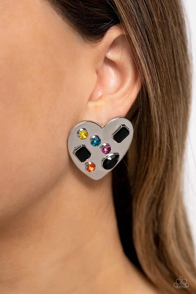 Paparazzi Accessories Relationship Ready - Black Brushed with shimmery pink, orange, yellow, blue, and black round, teardrop and emerald-cut gems, an oversized, high-sheen silver heart frame rests against the ear for a dazzling finish. Earring attaches to