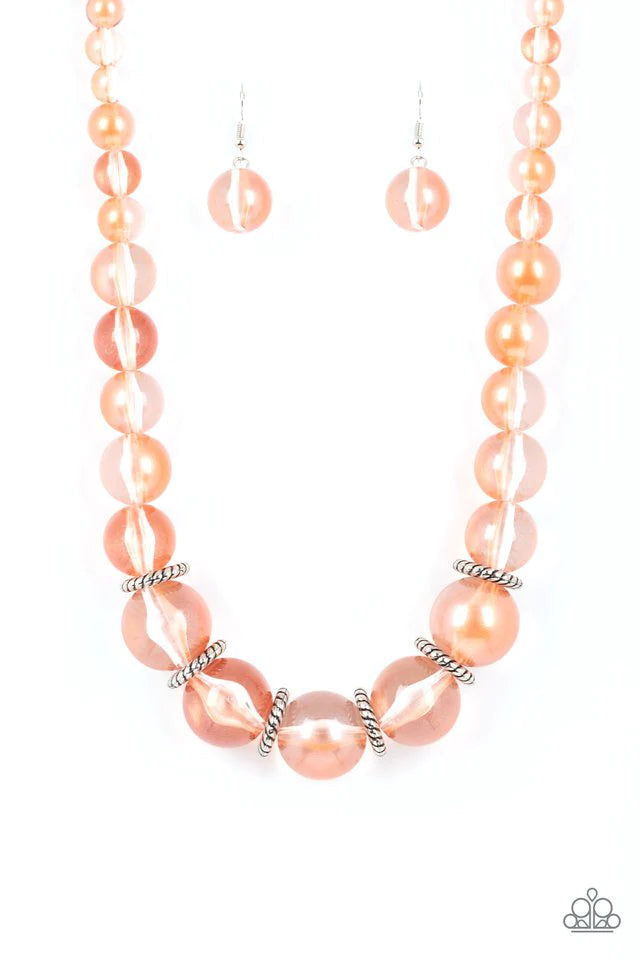 Paparazzi Accessories Marina Mirage - Orange Lightly brushed in a pearly Spun Sugar shimmer, glassy translucent beads gradually increase in size as they are threaded along an invisible wire below the collar. Textured silver rings separate the largest bead