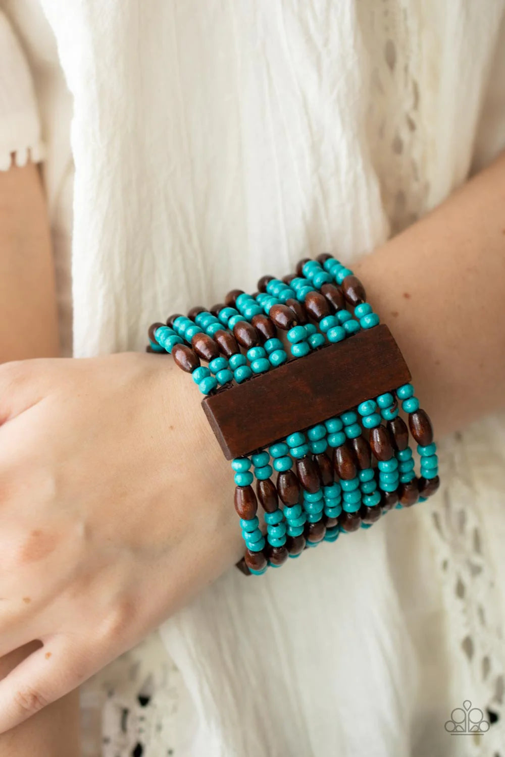 Paparazzi Accessories Tropical Takeover - Blue Stacked layers of bright turquoise and brown wooden beads are threaded along stretchy bands and wrap around the wrist in a linear pattern. Three wide wooden bars interrupt the pattern, adding weight to the tr