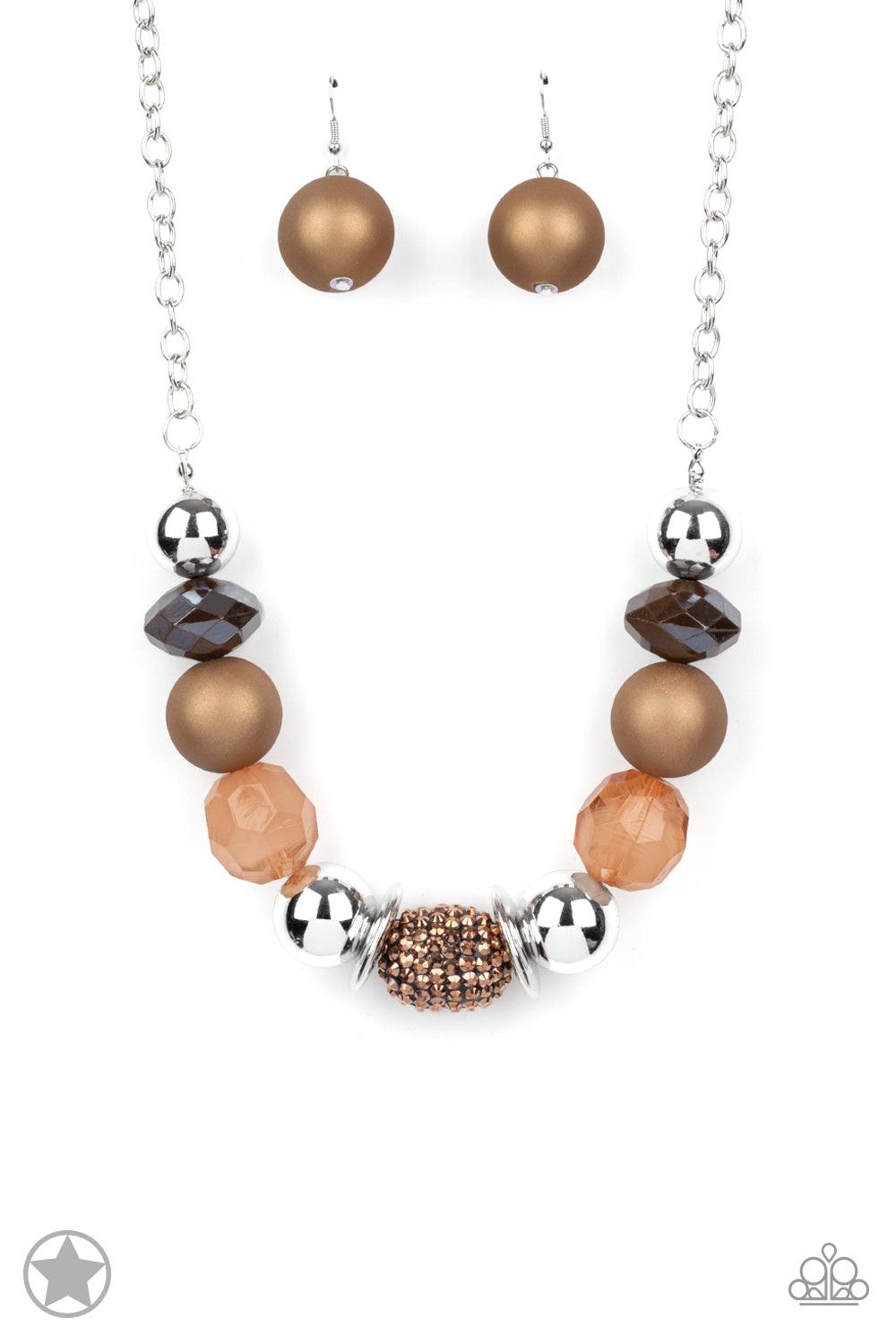Paparazzi Accessories A Warm Welcome - Brown Warm beads in shades of brown and copper with reflective faceted edges and varying glazed finishes are offset by two shiny silver beads. An oblong bead studded with copper-toned rhinestones adds a dramatic acce
