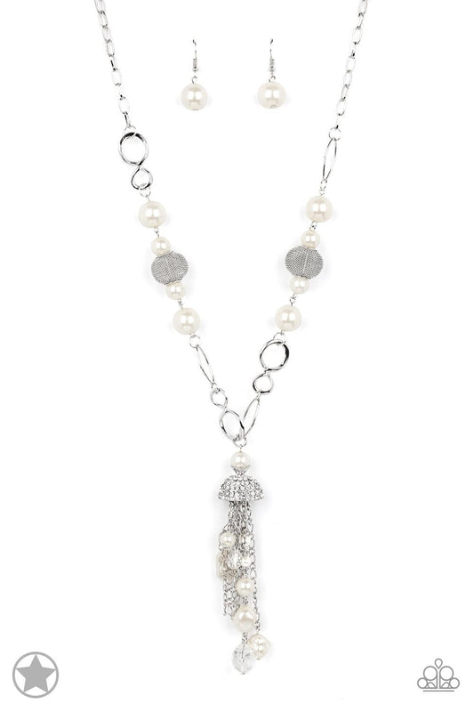 Paparazzi Accessories Designated Diva - White A half-shell studded in rhinestones overhangs a cluster of ivory pearls, tassels of silver chain, and small crystals. Two large wire mesh spheres and larger ivory pearls decorate the neckline. Sold as one indi