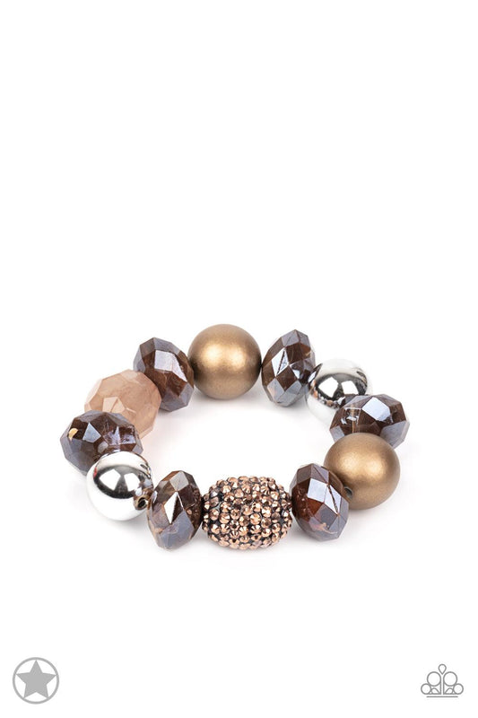 Paparazzi Accessories All Cozied Up Warm beads in shades of brown and copper with reflective faceted edges and varying glazed finishes are offset by two shiny silver beads. An oblong bead studded with copper-toned rhinestones adds a dramatic accent. Sold