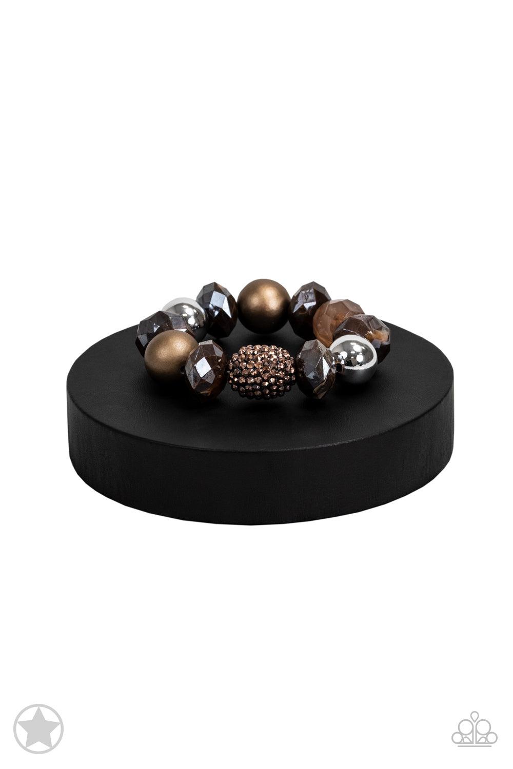 Paparazzi Accessories All Cozied Up Warm beads in shades of brown and copper with reflective faceted edges and varying glazed finishes are offset by two shiny silver beads. An oblong bead studded with copper-toned rhinestones adds a dramatic accent. Sold