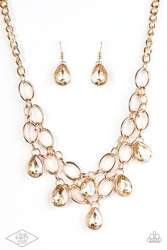 Paparazzi Accessories Show-Stopping Shimmer - Gold Joined by dainty gold links, two rows of dramatic gold chain layer below the collar in a fierce fashion. Golden teardrops drip from the glistening layers, adding a timeless shimmer to the show-stopping pi