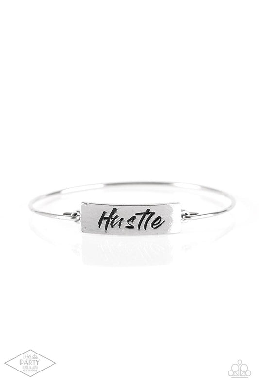 Paparazzi Accessories Hustle Hard - Silver Engraved with the inspiring word "Hustle", a shimmery silver plate attaches to a skinny silver bar, creating a dainty bangle. Sold as one individual bracelet. Jewelry