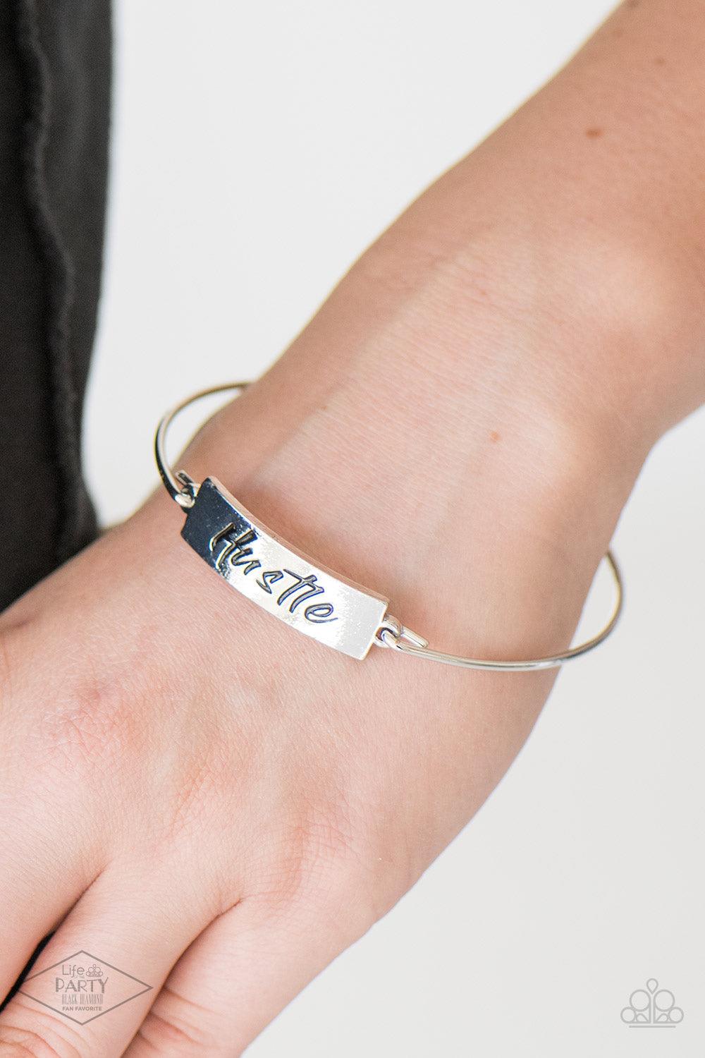 Paparazzi Accessories Hustle Hard - Silver Engraved with the inspiring word "Hustle", a shimmery silver plate attaches to a skinny silver bar, creating a dainty bangle. Sold as one individual bracelet. Jewelry