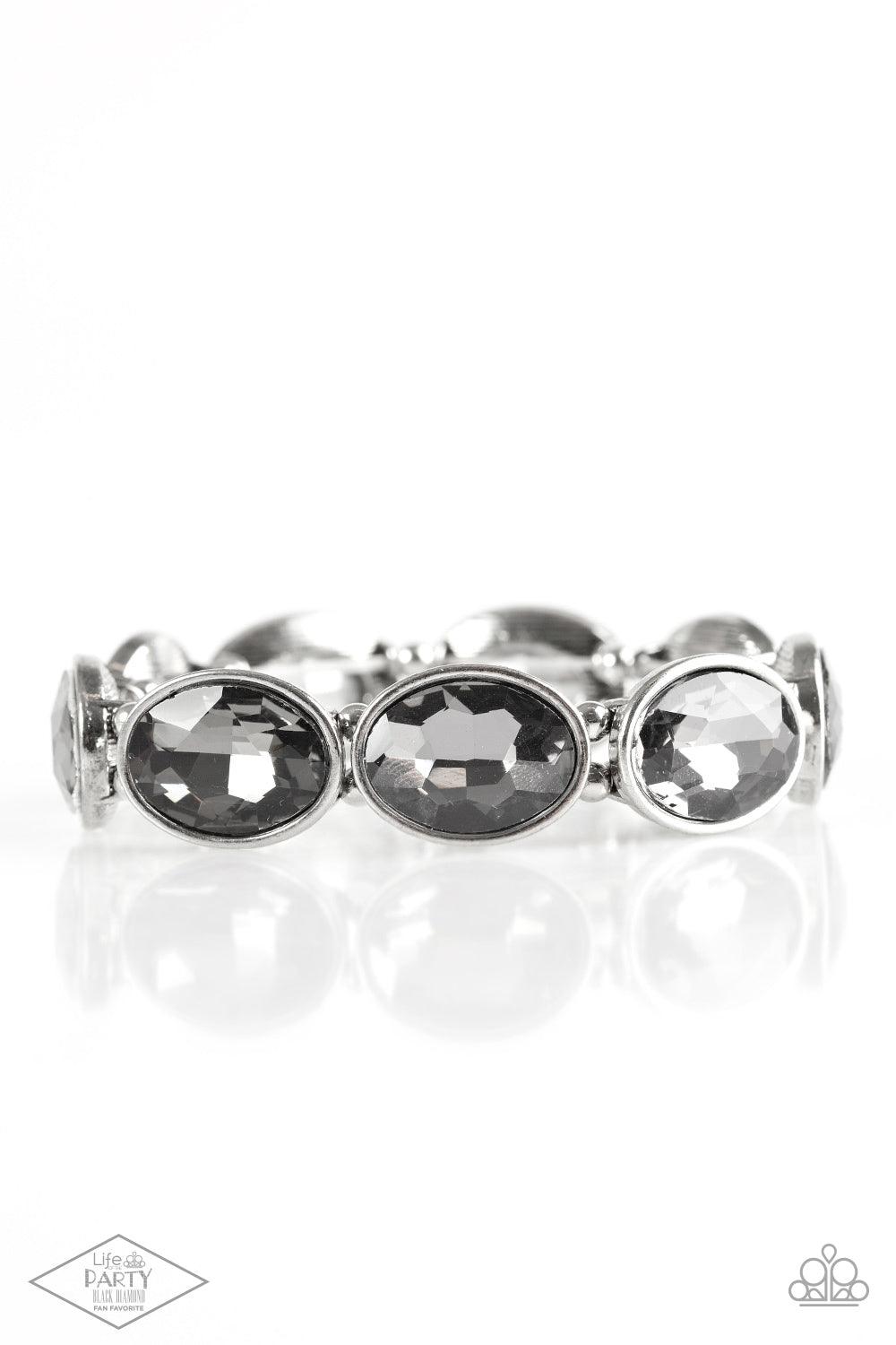 Paparazzi Accessories DIVA In Disguise - Silver Smoky gems are pressed into sleek silver frames. Infused with dainty silver beads, the glittery frames are threaded along stretchy elastic bands for a glamorous look around the wrist. Sold as one individual