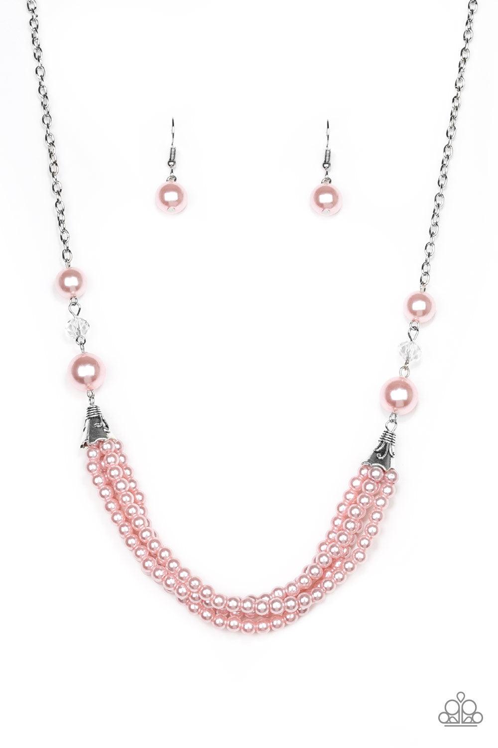 Paparazzi Accessories One-WOMAN Show - Pink Oversized pink pearls and crystal-like beads give way to layers of beaded pearl strands below the collar for a timeless look. Features an adjustable clasp closure. Sold as one individual necklace. Includes one p