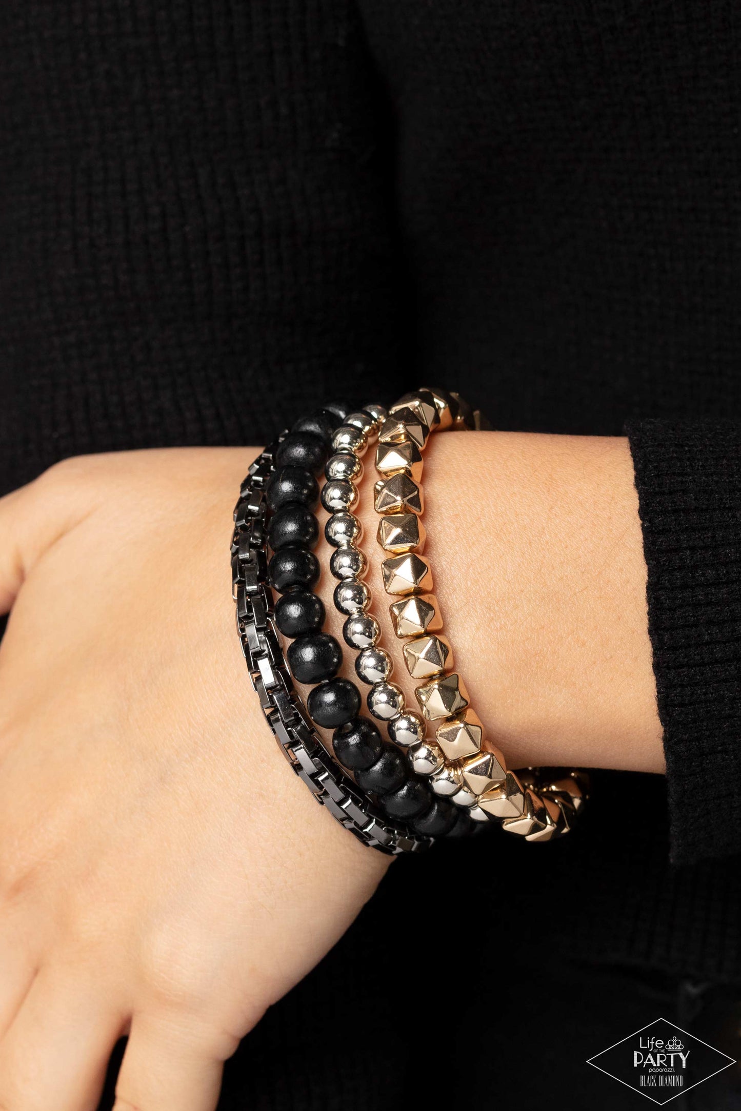 Paparazzi Accessories Retro Rocker - Multi A rock star mashup of gold, gunmetal, and silver beads collides with earthy wooden black beads that are threaded along stretchy bands, creating retro layers across the wrist. Sold as one set of four bracelets. Je