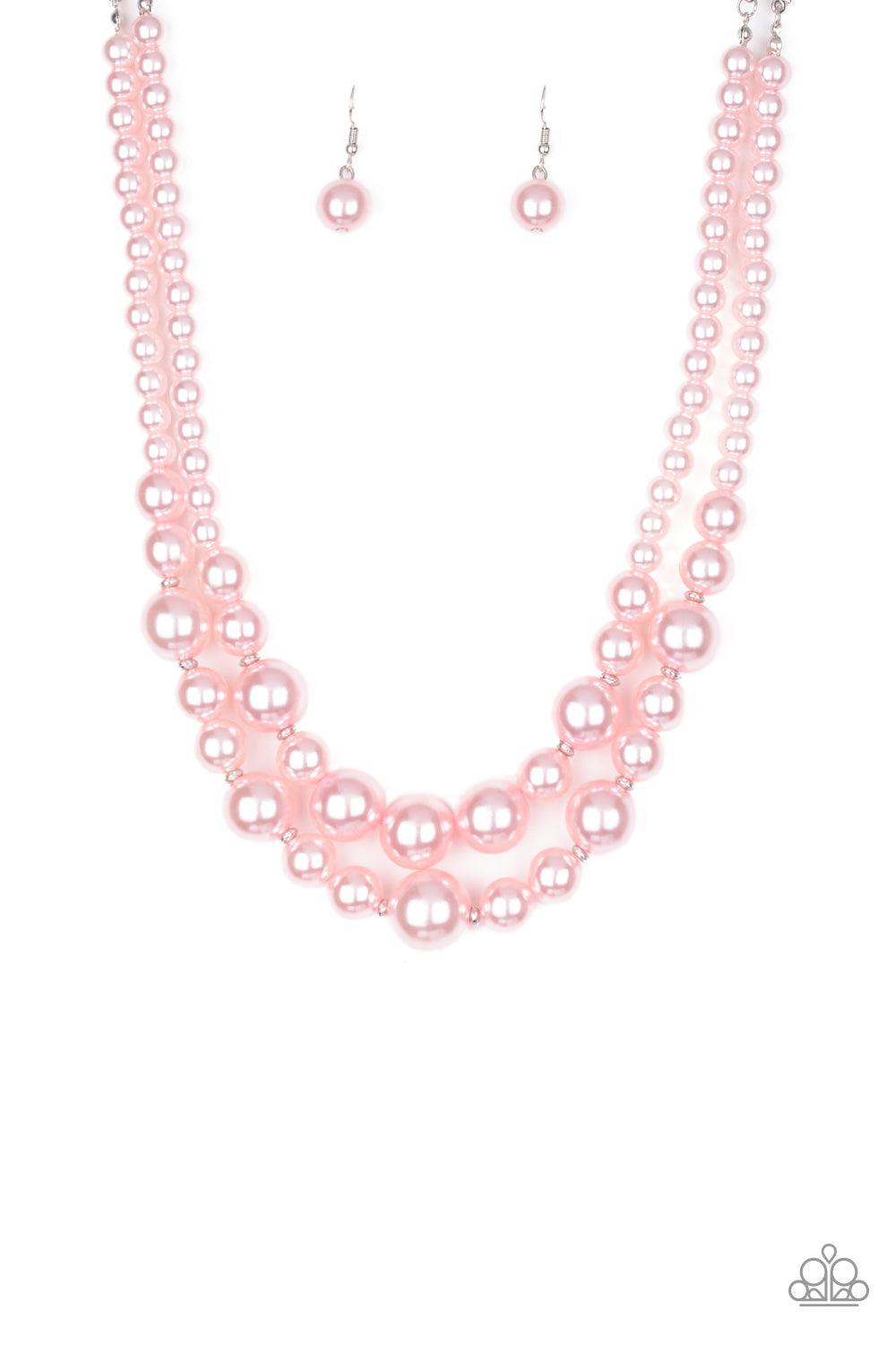 Paparazzi Accessories The More The Modest - Pink Infused with dainty silver accents, classic pink pearls layer below the collar in a timeless fashion. Features an adjustable clasp closure. Sold as one individual necklace. Includes one pair of matching ear