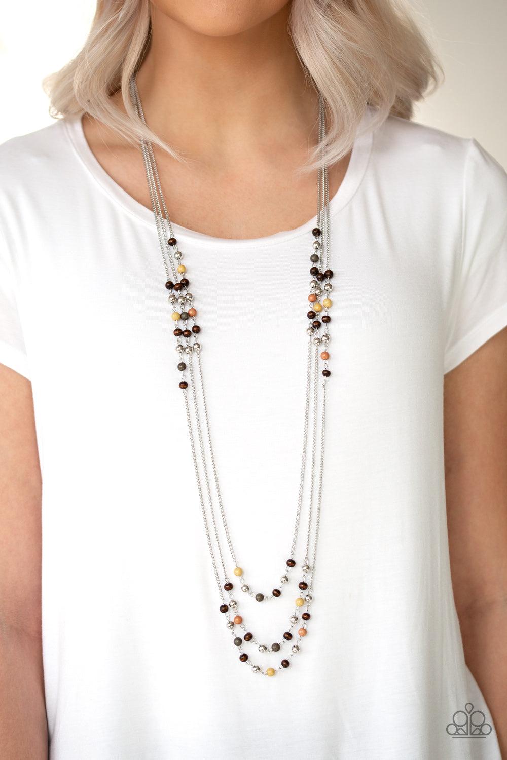 Paparazzi Accessories Seasonal Sensation - Multi Dainty brown, Aspen Gold, Terrarium Moss, and wooden beads trickle along three shimmery silver chains, creating colorful layers across the chest. Features an adjustable clasp closure. Sold as one individual