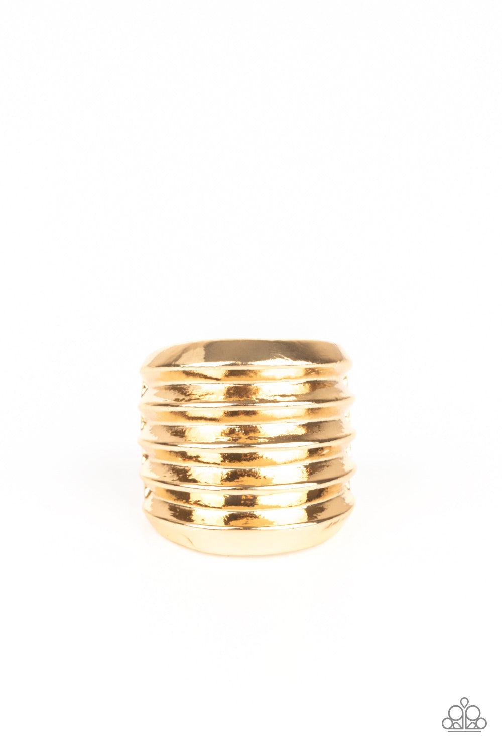 Paparazzi Accessories Hit Em Where It Hurts - Gold Rippling gold bands coalesce into a thick frame around the finger for a dramatic industrial look. Features a stretchy band for a flexible fit. Sold as one individual ring. Jewelry