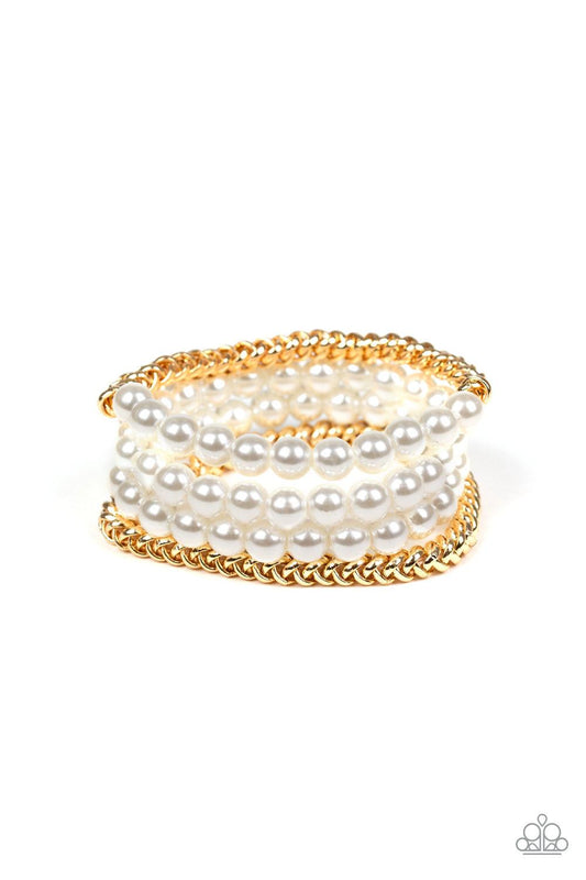 Paparazzi Accessories Industrial Incognito - Gold A collection of pearly white beads and glistening gold chains are threaded along stretchy bands, creating a bold collision of industrial glamour. Sold as one set of four bracelets. Jewelry