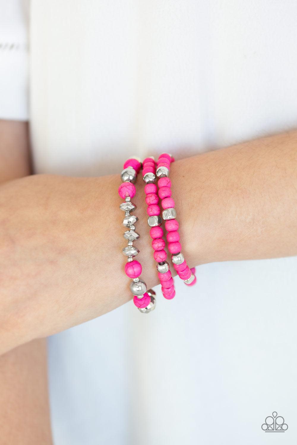 Paparazzi Accessories Mountain Artist - Pink A collection of vivacious pink stones, faceted pink beads, and shimmery silver accents are threaded along stretchy bands, creating colorful layers around the wrist. Sold as one set of three bracelets. Jewelry