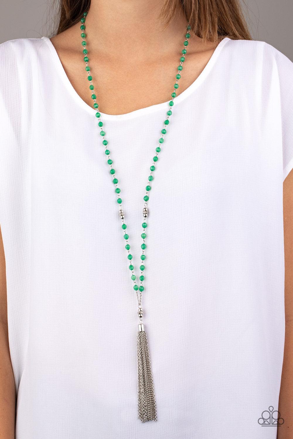 Paparazzi Accessories Tassel Takeover - Green Green opaque crystal-like beads, shiny silver beads, and white rhinestone encrusted rings give way to a shimmery silver tassel for a whimsical look. Features an adjustable clasp closure. Sold as one individual
