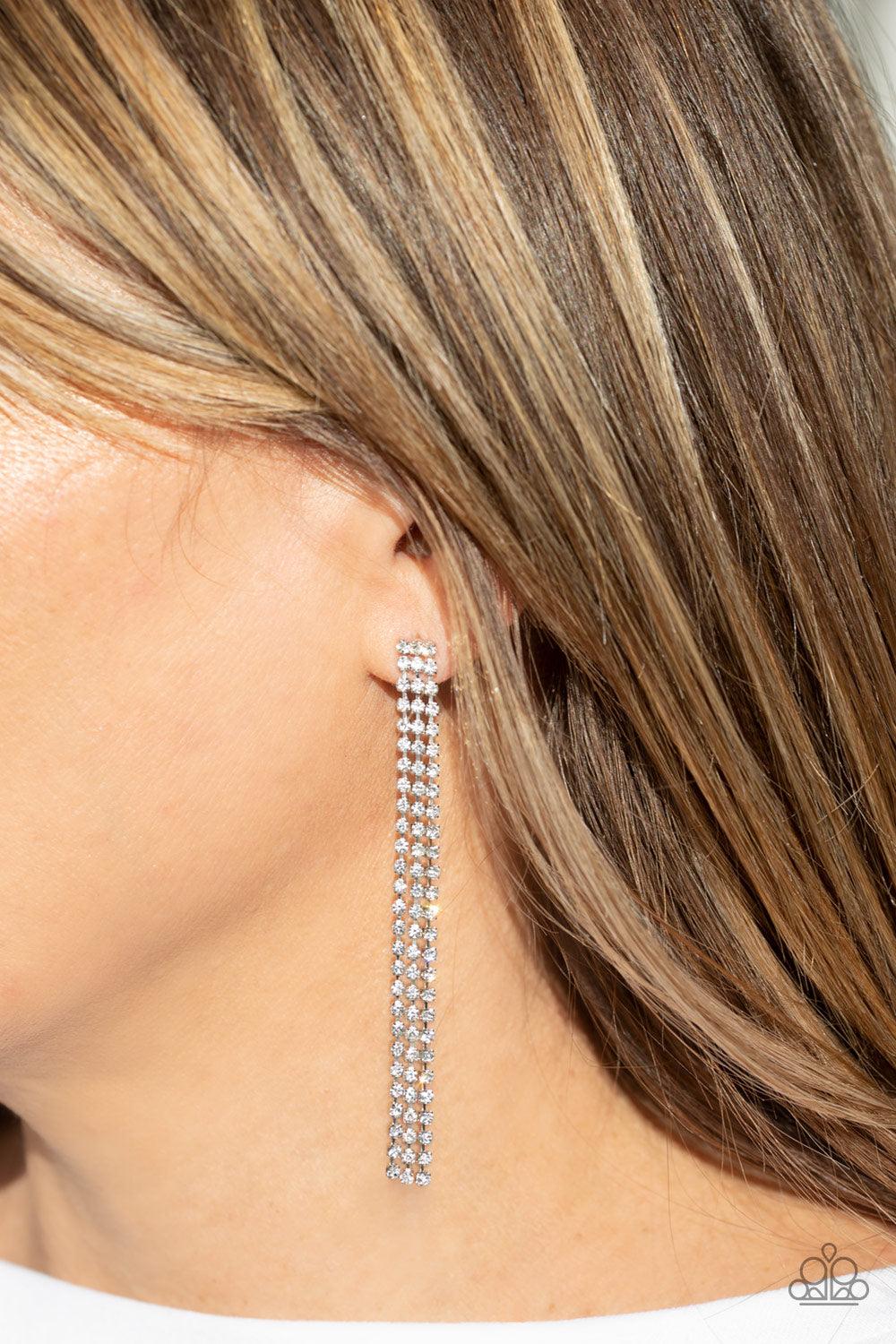 Paparazzi Accessories Stellar Starlight - White Three strands of glittery white rhinestones free-fall from the ear, coalescing into a timeless chandelier. Earring attaches to a standard post fitting. Sold as one pair of post earrings. Jewelry