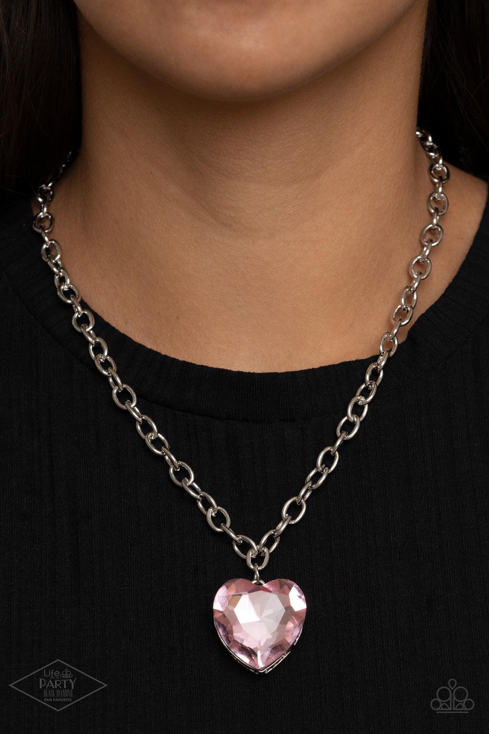 Paparazzi Accessories Flirtatiously Flashy - Pink Set atop a sleek silver fitting, a glittery pink heart-shaped gem swings from the bottom of a classic silver chain below the collar for a whimsical look. Features an adjustable clasp closure. Sold as one i