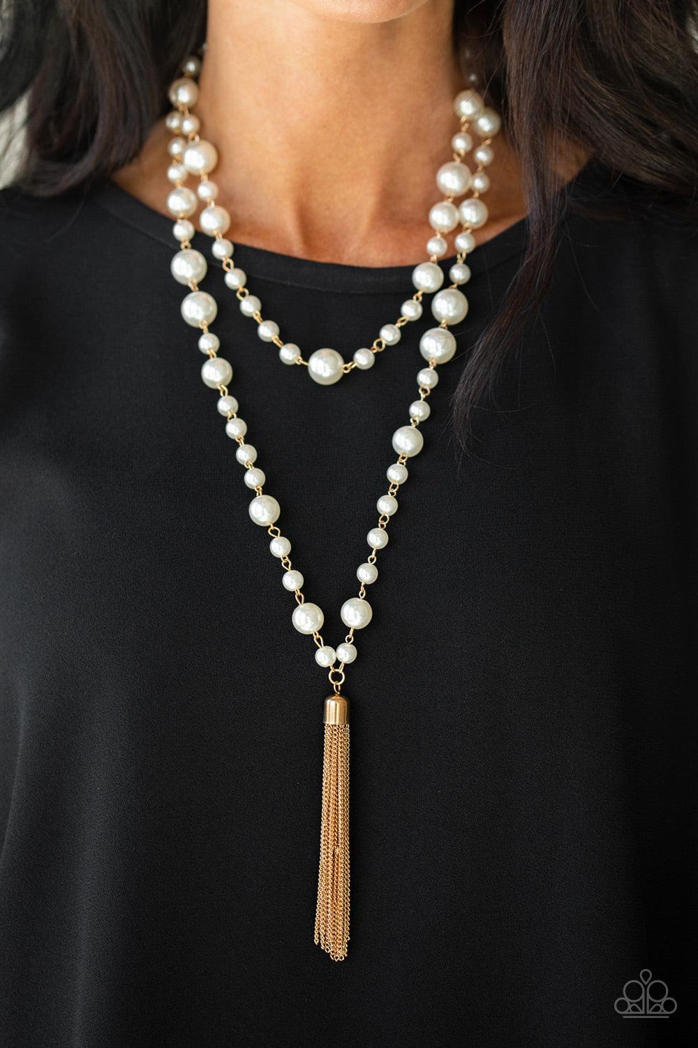 Paparazzi Accessories Social Hour - Gold A collection of bubbly white pearls link into two strands down the chest. A shimmery gold tassel swings from the lowermost strand, adding a timeless twist to the classic pearl palette. Features an adjustable clasp