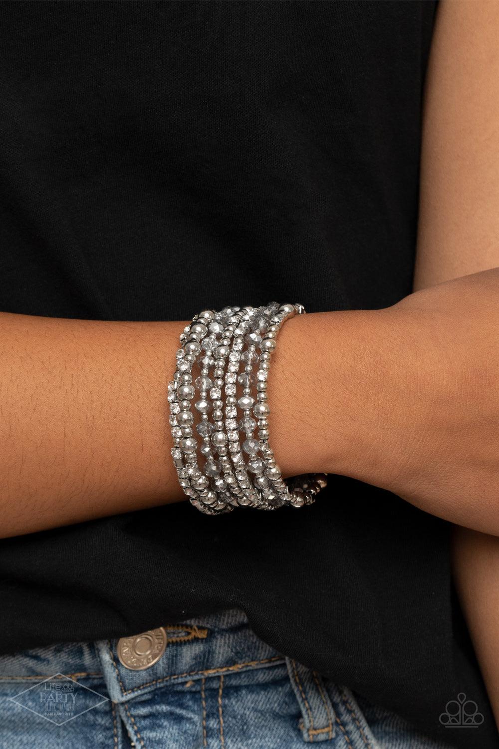 Paparazzi Accessories ICE Knowing You - Silver An icy collection of silver beads, silver cubes, metallic crystals, and glassy white rhinestones are threaded along a coiled wire, creating a blinding infinity wrap style bracelet around the wrist. Sold as on