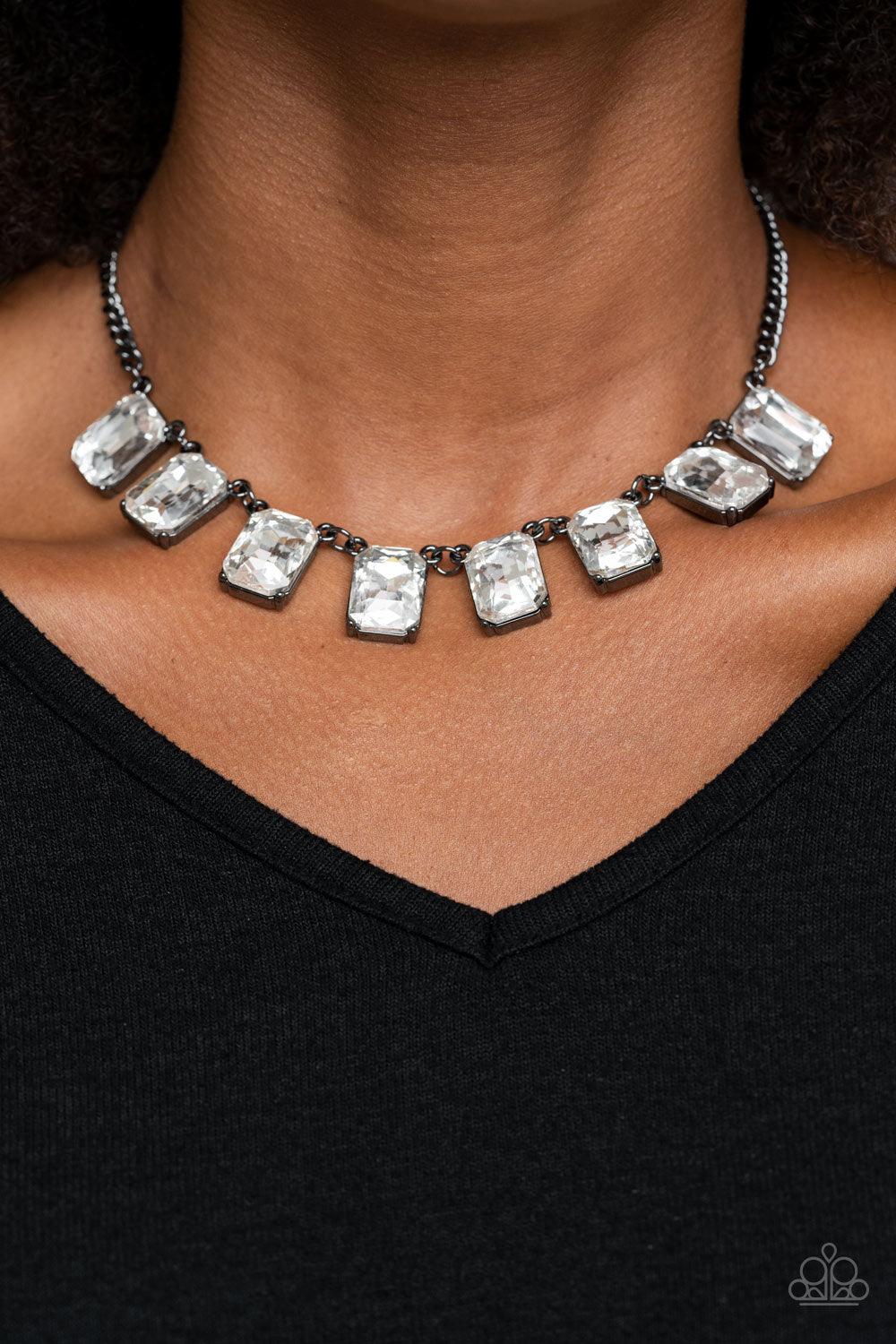 Paparazzi Accessories After Party Access - Black Encased in sleek gunmetal fittings, a regal chain of oversized white emerald style gems link below the collar for a timeless finish. Features an adjustable clasp closure. Sold as one individual necklace. In