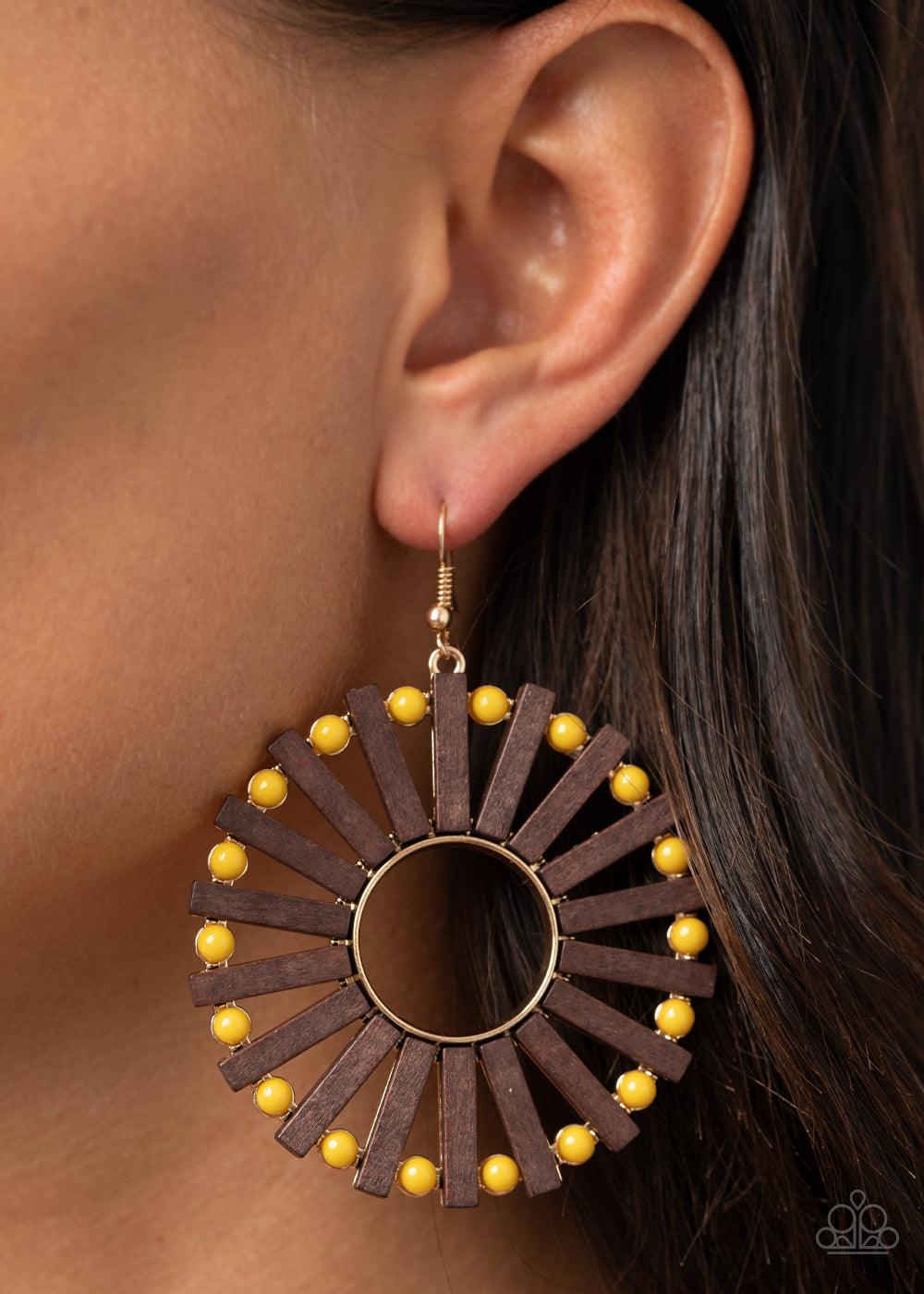 Paparazzi Accessories Solar Flare - Yellow Separated by dainty yellow beads, a series of wooden rectangular frames fan out from a golden ringed center for an earthy flair. Earring attaches to a standard fishhook fitting. Sold as one pair of earrings. Jewe