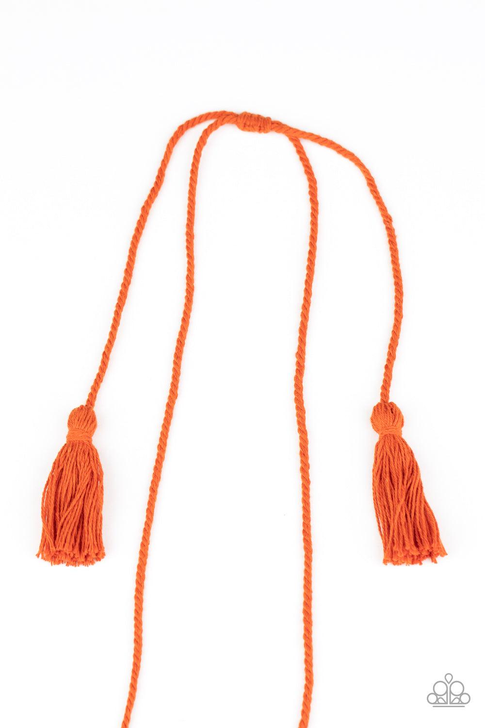 Paparazzi Accessories Between You and MACRAME - Orange Orange cording delicately wraps around a dainty wooden dowel, knotting into a tasseled macrame centerpiece at the bottom of a dramatically lengthened display. Features an adjustable sliding knot closu
