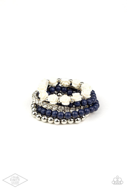 Paparazzi Accessories Rose Garden Grandeur - Blue A vintage inspired collection of ivory resin roses, navy beads, and classic silver beads join a stretchy band of glittery white rhinestones dotted around the wrist for a flawlessly stacked look. Sold as on