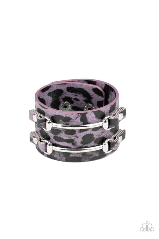 Paparazzi Accessories Safari Scene - Purple Two arcing silver bars are studded in place across the front of a thick leather band painted in purple and black cheetah print for a wild look. Features an adjustable snap closure. Sold as one individual bracele